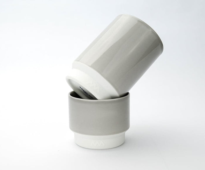 Two Asemi Hasami large cups in light grey stacked together, showing the soft glazed exterior and white base.