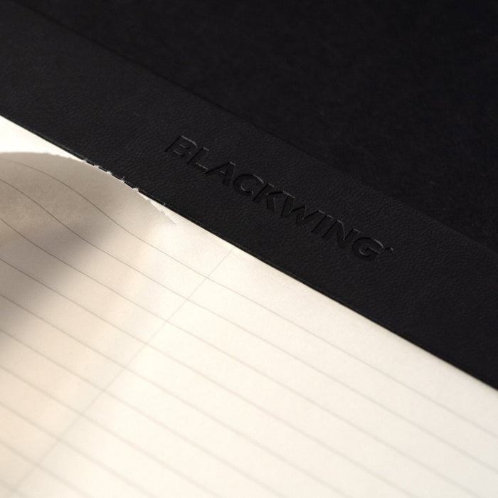 The Journal Shop - Detailed view of the Blackwing logo embossed on the black top binding strip.