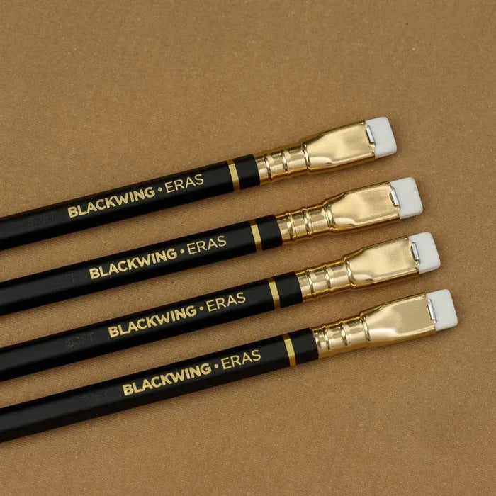 Close-up of four Blackwing Eras 2025 Edition pencils highlighting the gold ferrule and retro eraser design.