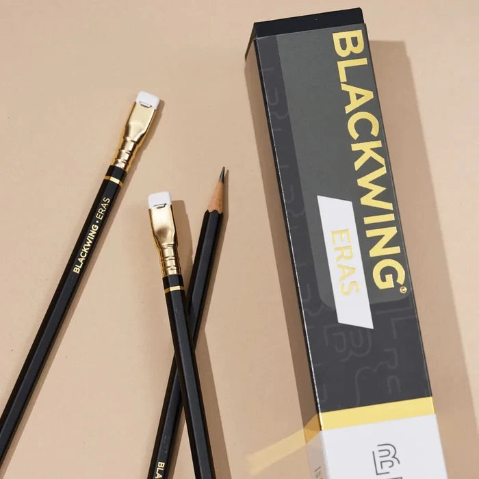 Blackwing Eras 2025 Edition pencils placed on a table with one pencil angled upright.