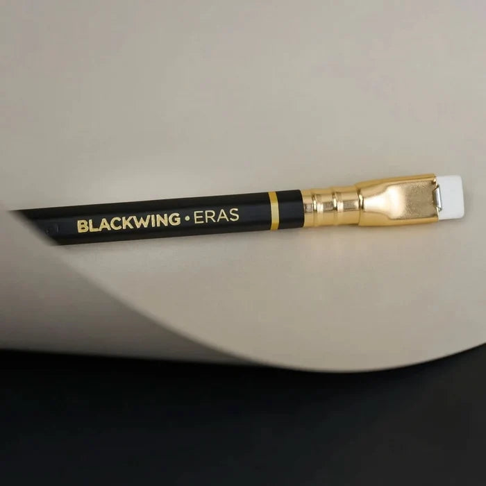 Side view of a Blackwing Eras 2025 Edition pencil set against a black-and-biege background.