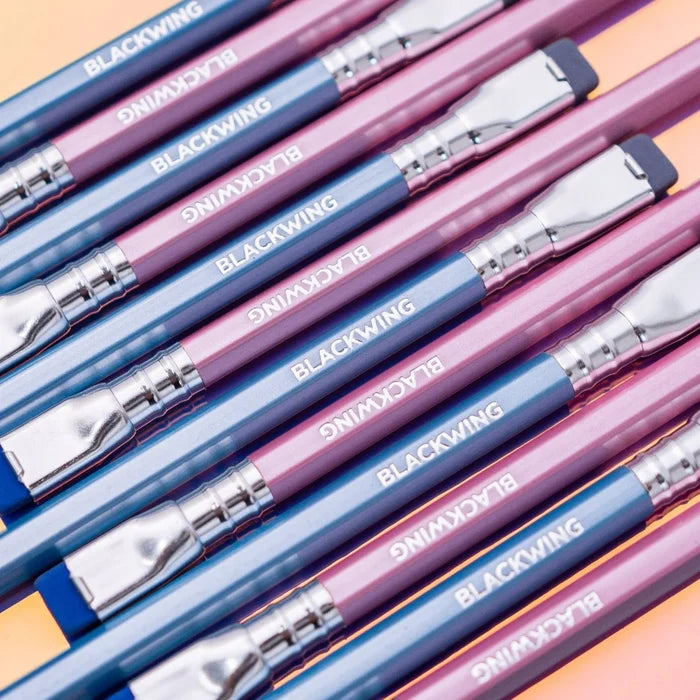 Selection of assorted Blackwing pencils in pink, blue, and white finishes arranged side by side