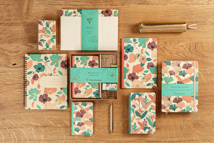 Complete selection of Gaïa Beige stationery pieces displayed neatly on a wooden table.