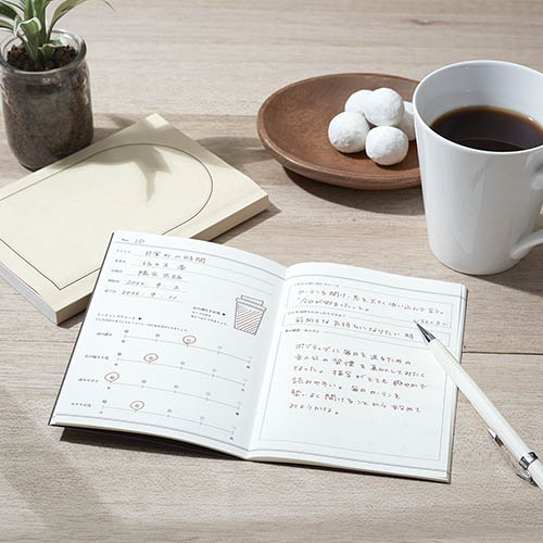 Daigo Teatime Reading Journal open on a desk with tea and stationery.