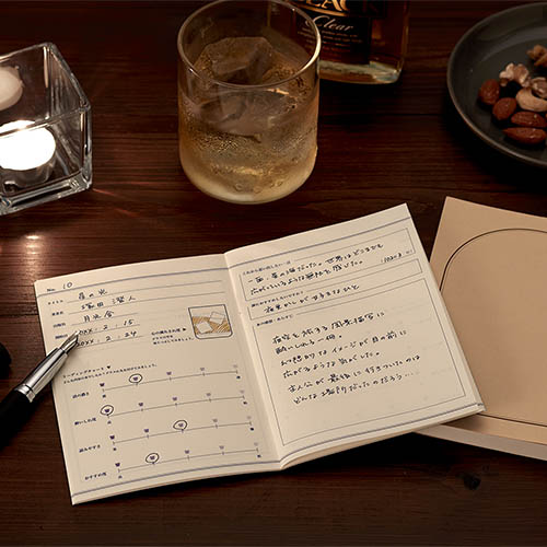 Daigo Teatime Reading Journal open beside a cup of tea in a cosy café setting.