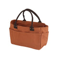 The Journal Shop - Brown Dulton Canvas Shoulder Tote Bag placed on the ground, highlighting its structured shape and compartments.