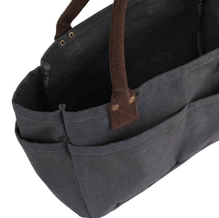 The Journal Shop - Close-up of a dark grey Dulton Canvas Shoulder Tote Bag showing multiple pockets and reinforced handles.