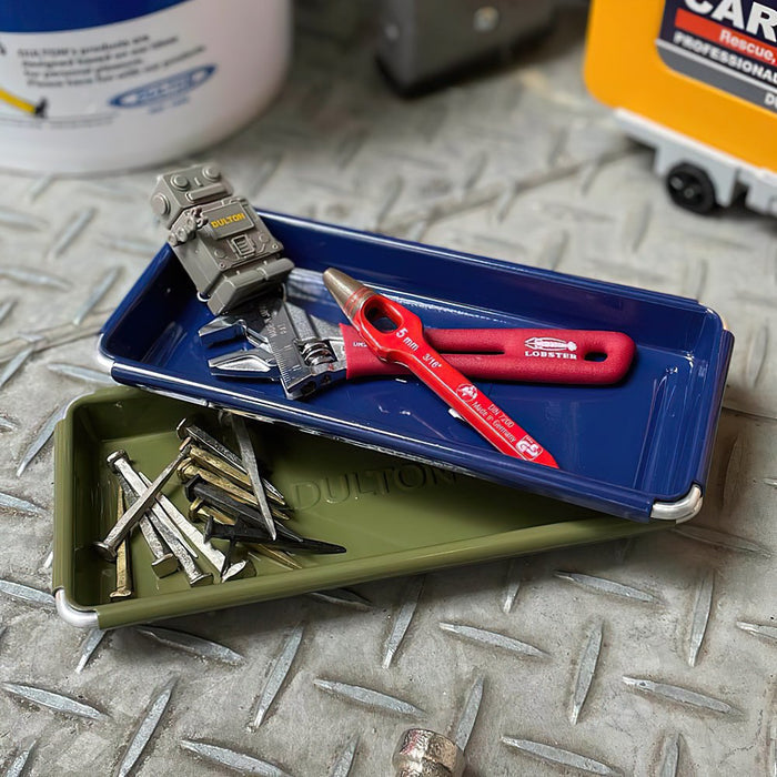 The Journal Shop - Navy Blue Dulton Desktop Tray holding red pliers, scissors, and other small desk tools on a metal surface.