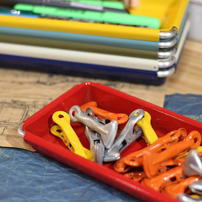 The Journal Shop - Stack of Dulton Desktop Trays in assorted colours, including a red tray used to hold the clips.