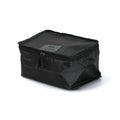 Side view of the black Nähe travel packing bag with zip closure and compact form.