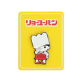 Character enamel pin displayed on a vibrant yellow backing card with stylised Japanese writing.