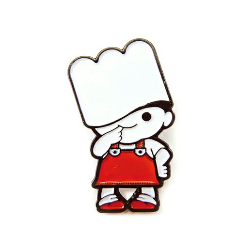 Close-up of the enamel pin showing a cartoon chef character in red overalls and oversized white hat.