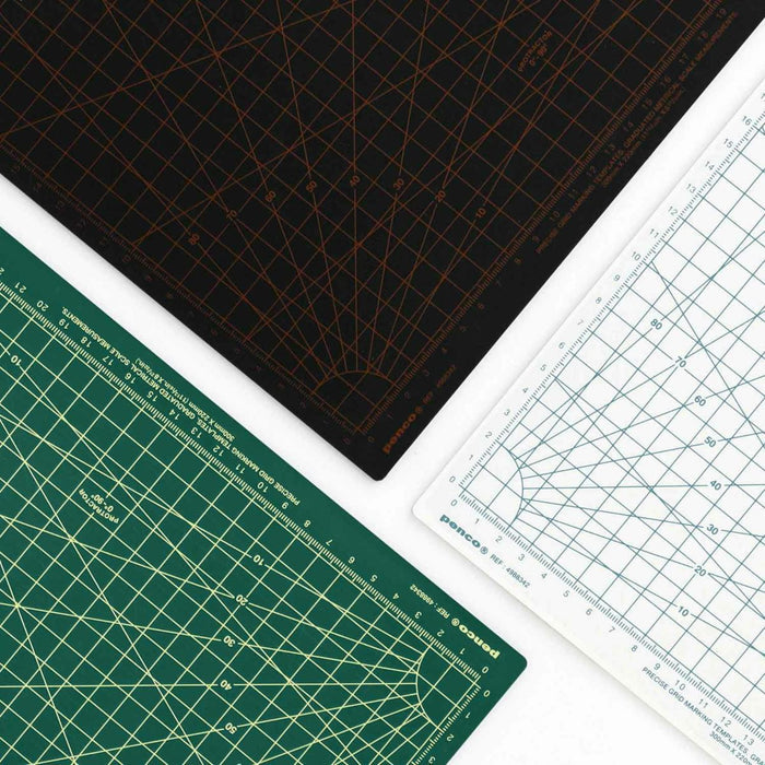 Overhead view of Penco cutting mats in black, green, and white with precision markings and grid templates.