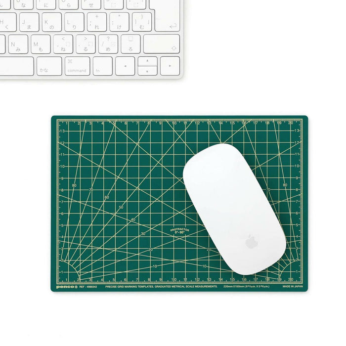 Green cutting mat by Penco used as a mouse pad, shown with Apple Magic Mouse and keyboard