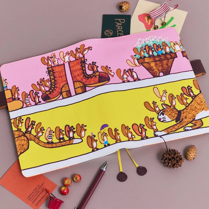 Hobonichi 2026 A5 Cousin Cover: 100%ORANGE - Where’s the Squirrel Going, shown in full.