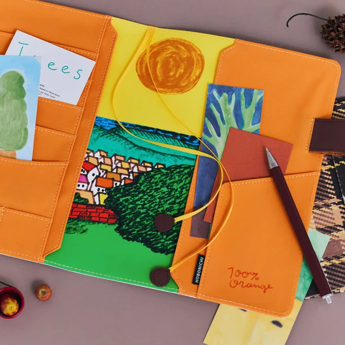 Hobonichi 2026 A5 Cousin Cover: 100%ORANGE - Where’s the Squirrel Going, close-up view.