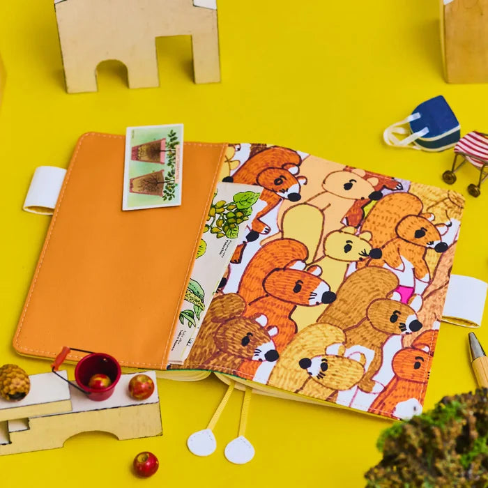Hobonichi 2026 A6 Planner Cover: 100%ORANGE - Squirrel Squadron, shown in full.