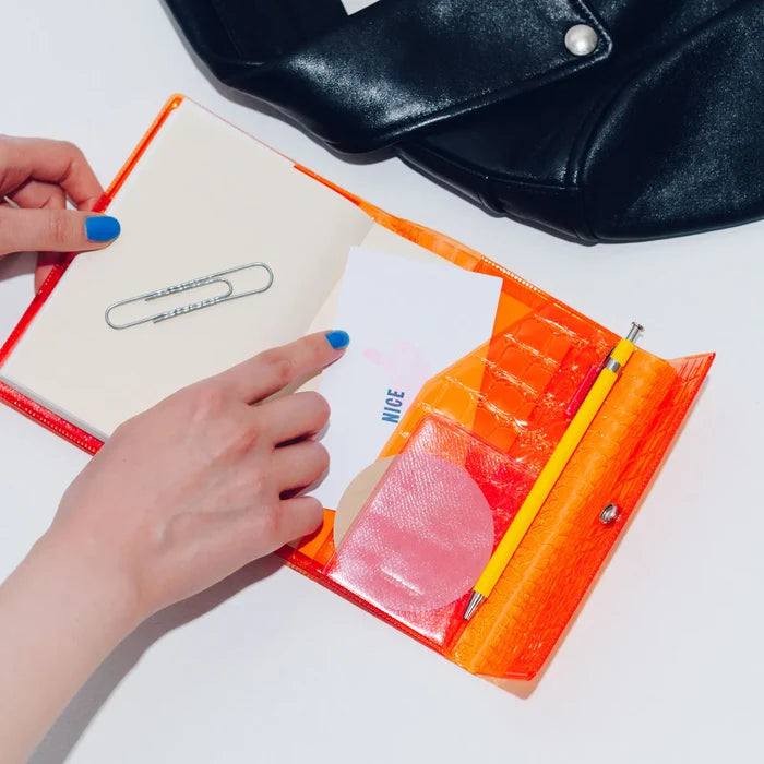 Hobonichi 2026 A6 Planner Cover: beautiful people - Nothing to Hide (Orange), close-up view.