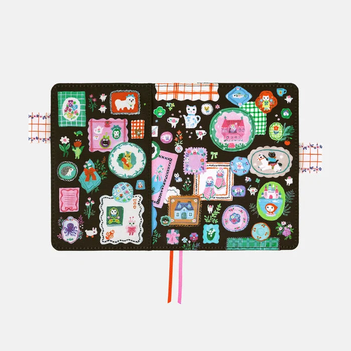 Hobonichi 2026 A6 Planner Cover: Yumi Kitagishi - White Cat's Table Decorations, shown from another angle.
