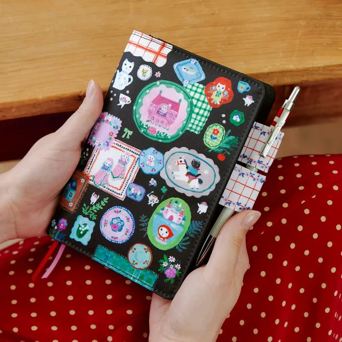 Hobonichi 2026 A6 Planner Cover: Yumi Kitagishi - White Cat's Table Decorations, detail view of the design.