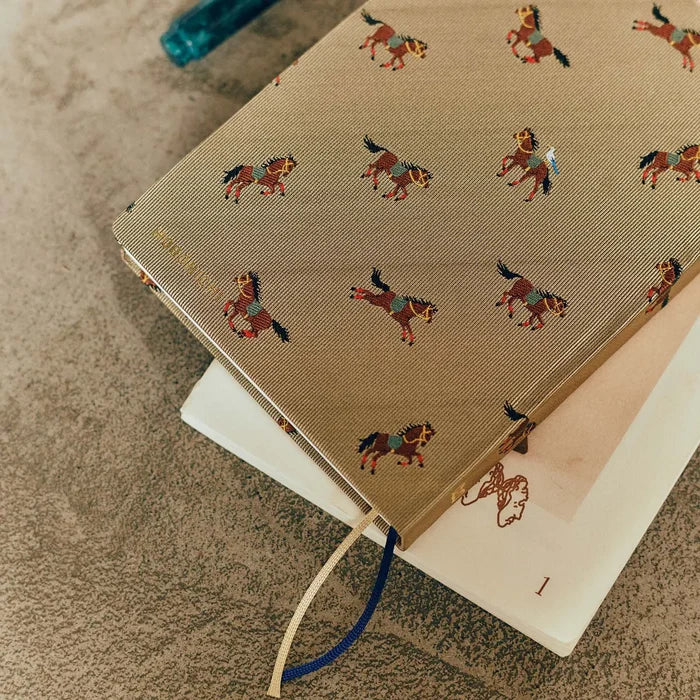 Hobonichi HON A6 2026 Planner: Bow & Tie - Galloping Horses, close-up view.
