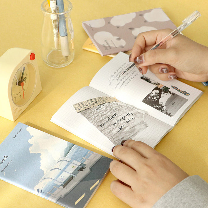 Iconic Adorable Handy Pocket Notebook v.3 being written in, showing compact size and 4mm grid layout.