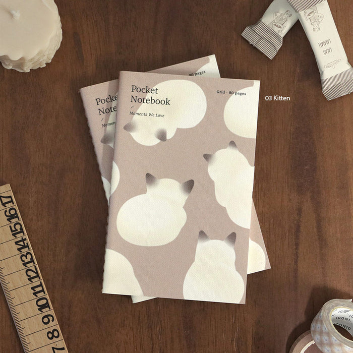 Iconic Adorable Handy Pocket Notebook v.3 displayed with stationery accessories in a flat lay.