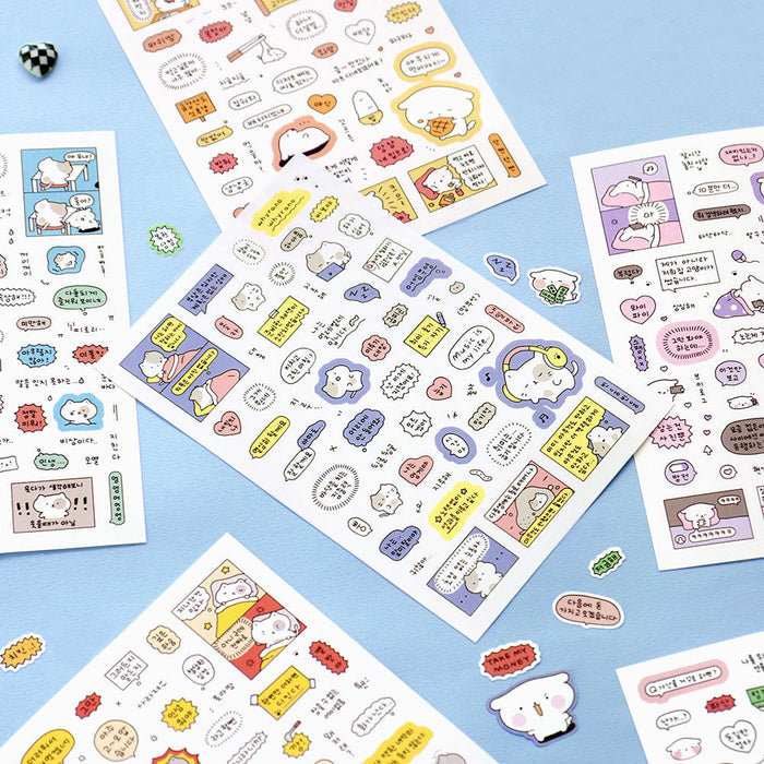 The Journal Shop - Assorted sheets of Iconic Blah Blah Daily Stickers laid out on a blue surface showing various cheerful designs.