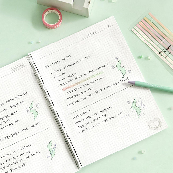 The Journal Shop - Iconic Blah Blah B5 Spiral Grid Notebook open with handwritten notes and pen on desk.