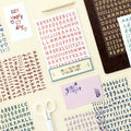 The Journal Shop - Collection of Iconic Calli Alphabet Stickers in assorted colours laid out on a desk with stationery items.