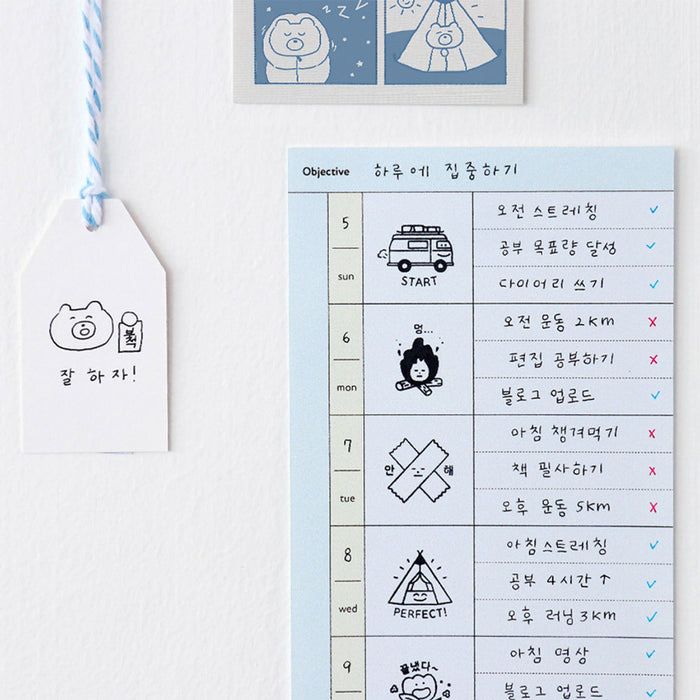 The Journal Shop - Notebook page featuring a checklist and camping icons stamped beside handwritten notes.
