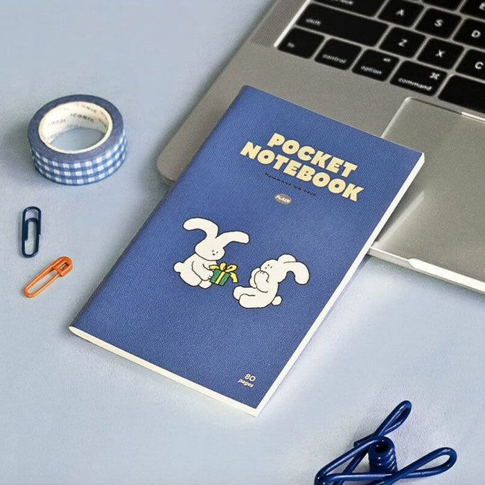 Iconic Charming Handy Pocket Notebook v.3 plain beside a laptop on a work surface.