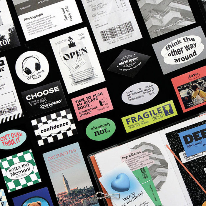The Journal Shop - Collection of Iconic Collect Stickers in assorted designs and colours arranged on a black background.