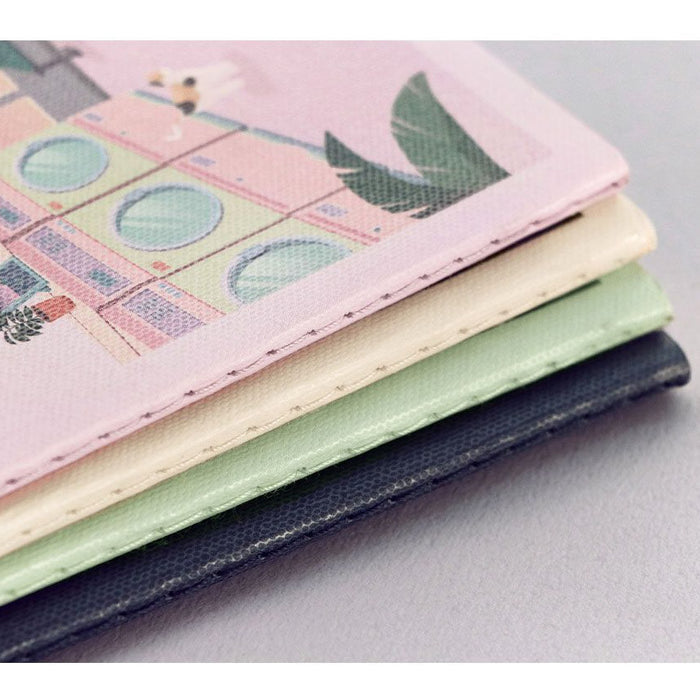 Stack of Iconic Daily Life Pocket Notebook v.3 lined notebooks showing slim profile and pastel covers.
