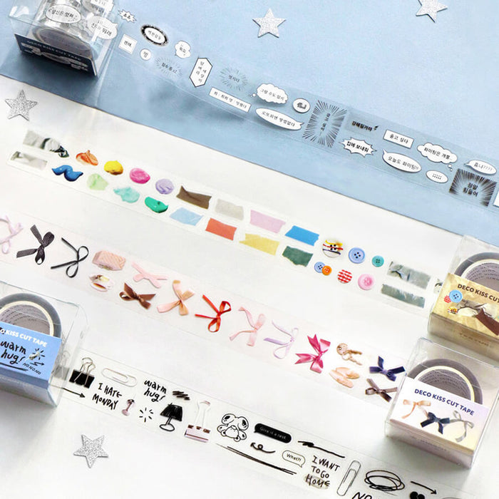 The Journal Shop - A collection of Iconic Deco Kiss-Cut Tape rolls unrolled on a pastel blue background, displaying various decorative designs including ribbons, drawing, cartoon, and texture.