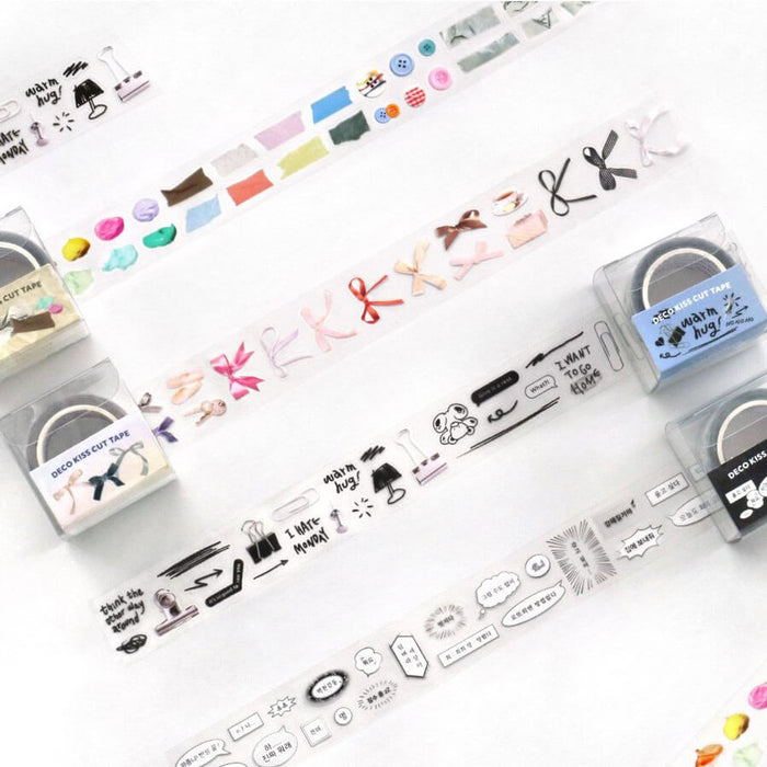 The Journal Shop - Multiple rolls of Iconic Deco Kiss-Cut Tape laid out on a white surface, showing colourful patterns and text-based designs.
