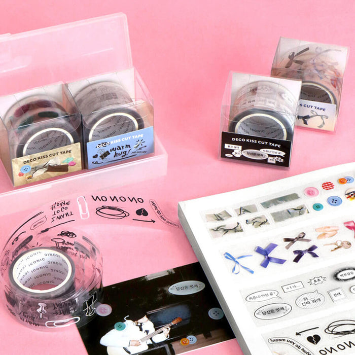The Journal Shop - Iconic Deco Kiss-Cut Tape in different styles displayed on a pink background, featuring packaging and unrolled tape samples.
