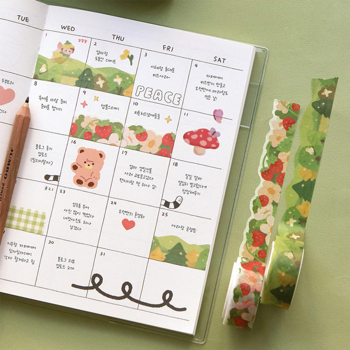 The Journal Shop - Different rolls of Iconic Die-Cut Paper Masking Tape displayed beside an open planner decorated with the tapes.