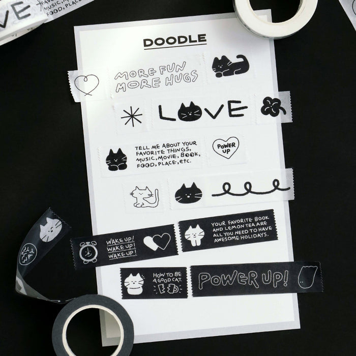 The Journal Shop - Black and white Iconic Doodle Masking Tape rolls with illustrated motifs arranged on a desk.