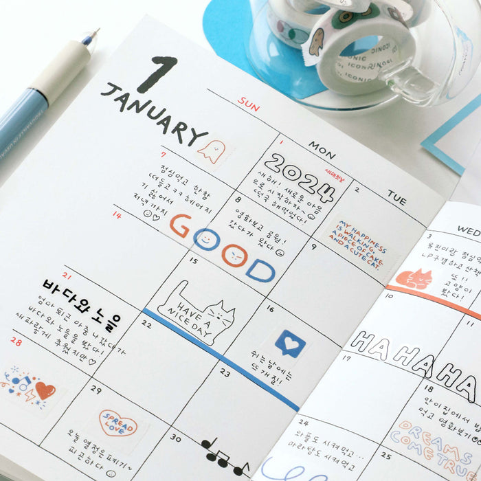 The Journal Shop - Planner decorated with strips of Iconic Doodle Masking Tape featuring small doodles and words.