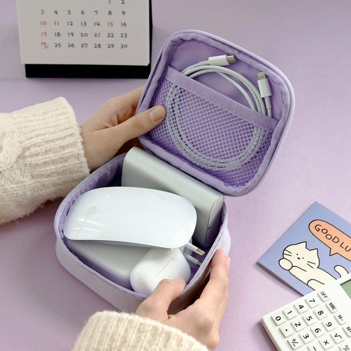 The Journal Shop - Lavender Doodle Mini Pouch open on a desk with power bank, charger cord and earbuds neatly arranged inside.
