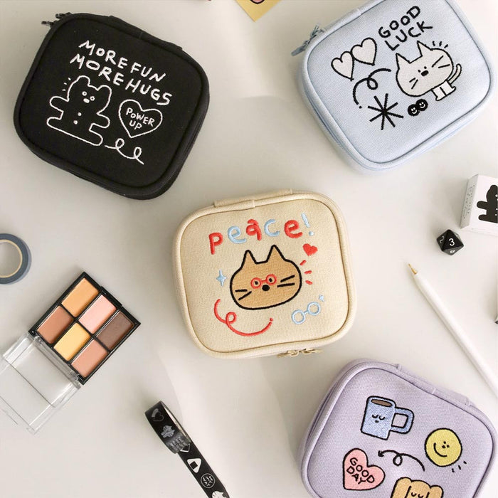 The Journal Shop - Variety of Doodle Mini Pouches with illustrated designs displayed alongside compact daily essentials.