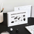 The Journal Shop - Black and white Doodle Study Planner open beside stationery and a study checklist layout.