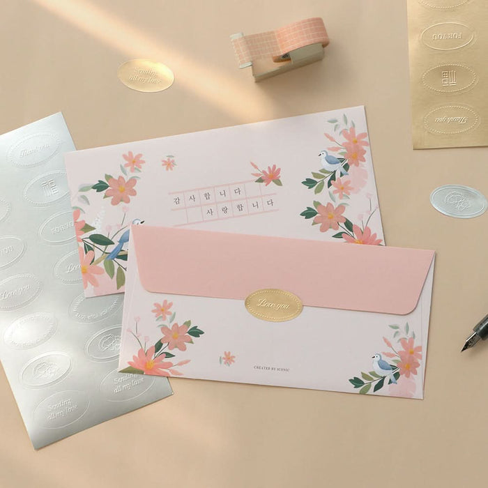 The Journal Shop - Close-up of pastel and floral Iconic Fortune Envelopes arranged neatly on a beige surface.
