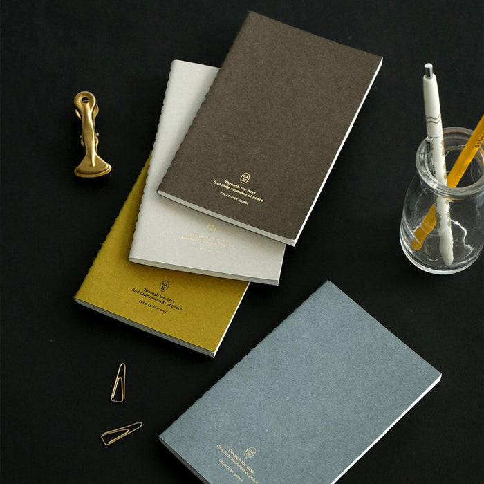 Iconic Haze pocket notebooks with 7mm lined pages in yellow, neutral grey, brown and blue tones.