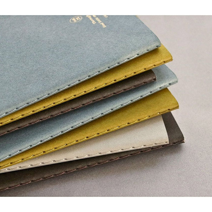 Stack of Iconic Haze pocket notebooks in coordinated neutral colours.