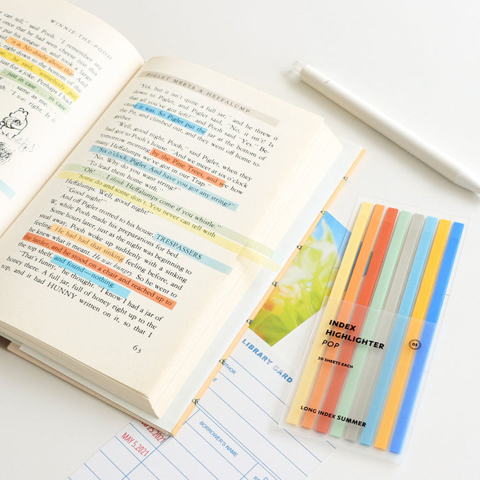 Iconic Index Long Highlighter POP set shown on a pink desk with stationery items.