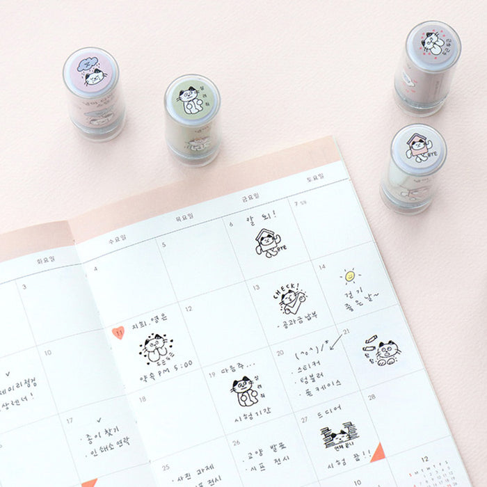 The Journal Shop - Selection of Meow Self Inking Stamps and stamped designs shown on planner pages.