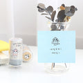 The Journal Shop - Blue Meow Self Inking Stamp used to mark a note on a desk beside stationery and organisers.