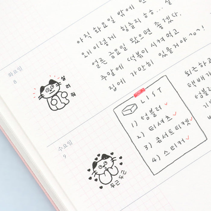 The Journal Shop - Meow Self Inking Stamp and planner open on a desk, displaying stamped designs for daily notes.
